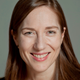 A closeup headshot of Heather Boushey, president of the Center for Equitable Growth, smiling at the camera.